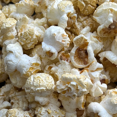 close up of popped popcorn with green chile powder.