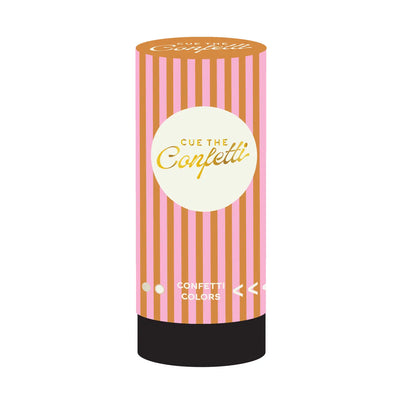 Pink and orange striped cylindrical confetti popper labeled “Cue the Confetti” with a round cream-colored label and black base.