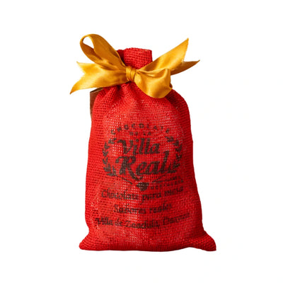 red burlap bag with a gold ribbon featuring black branded lettering.
