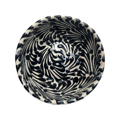 Top view of a ceramic bowl with a white and black Puebla design