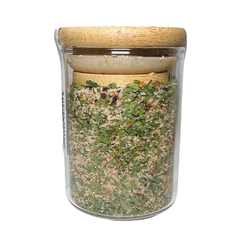 2oz clear jar with bamboo lid featuring various salt, chiles and herbs.