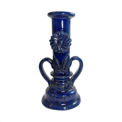 Blue candlestick holder featurig two handles and a flower on the center.
