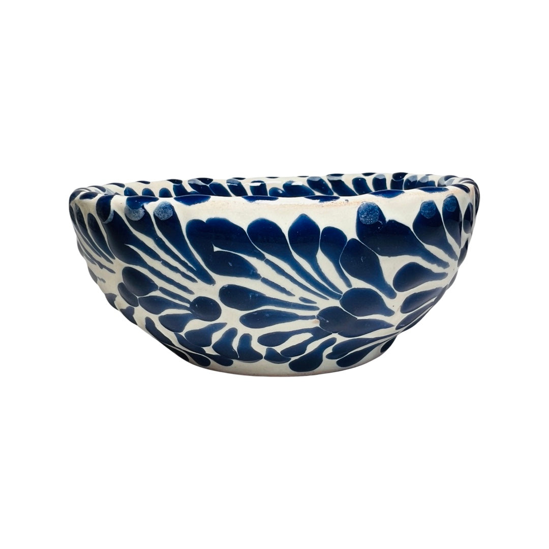 Side view of a ceramic bowl with a white and blue Puebla design