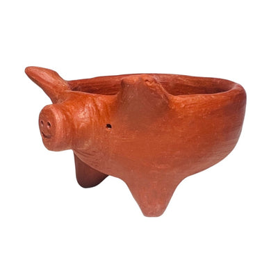 side view of a pig shaped red clay bowl