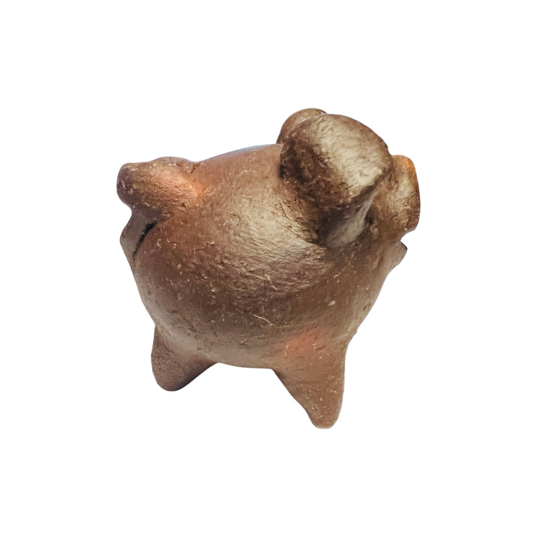 Side view of a red clay pig