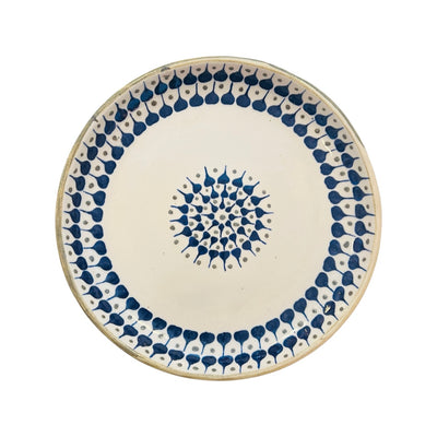 Cream ceramic dinner plate with a blue and brown design