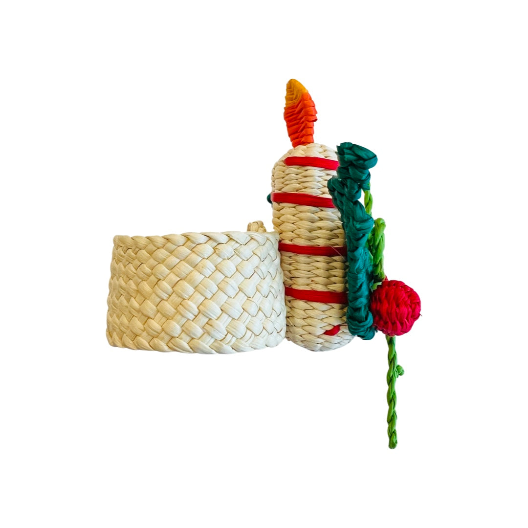 side view of A woven Christmas Candle napkin ring featuring a festive design of a colorful candle with holly leaves and berries, crafted from natural fibers, perfect for holiday table settings.