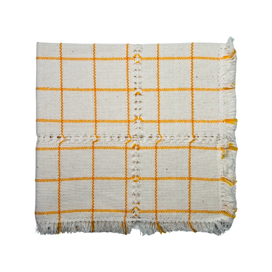 Orange and natural plaid handwoven napkin folded in quarter