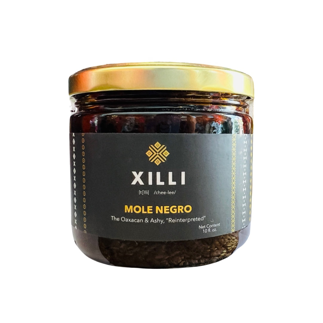 10 oz jar of mole negro with black branded labeling and a gold lid