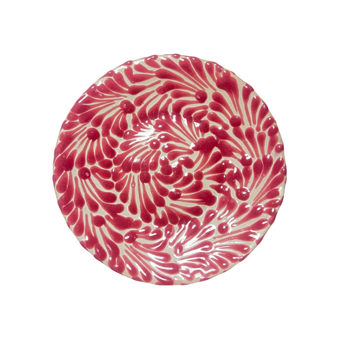 small white plate featuring a pink and white glazed design