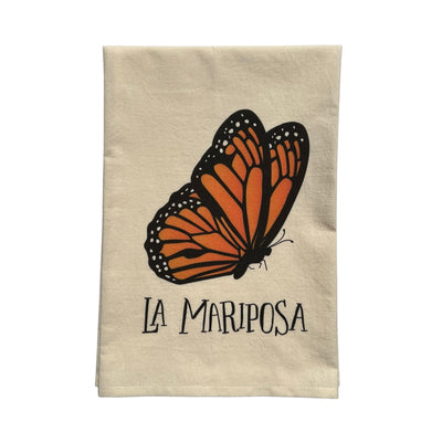 beige towel with an image of a monarch butterfly and the phrase La Mariposa in black lettering