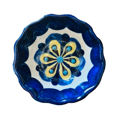 A hand-painted Blue Flor Tapas Dish with a scalloped edge, featuring a traditional Talavera-style floral pattern in shades of blue, white, and yellow. 