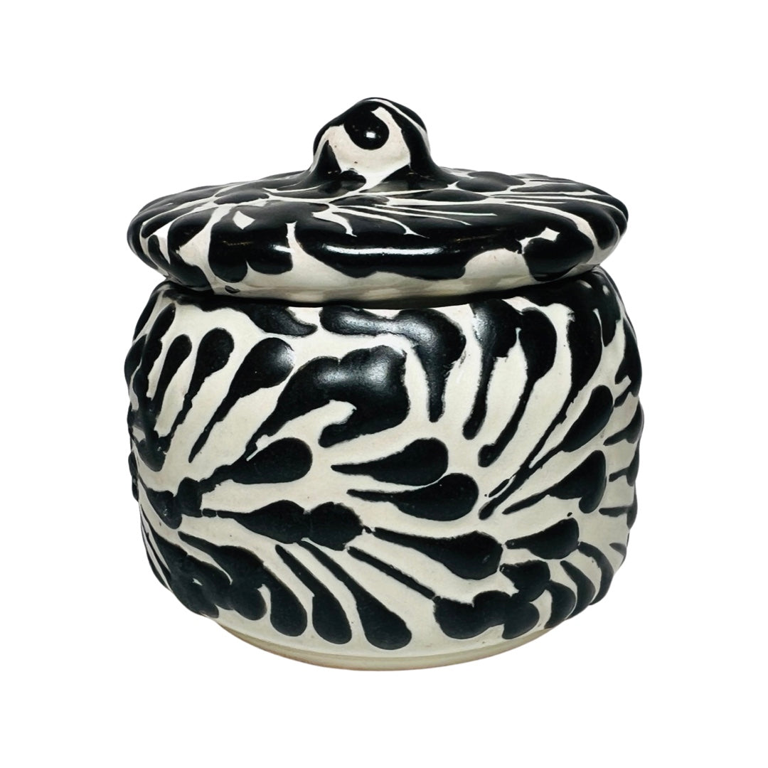 Side view of a ceramic container with a black and white Puebla design