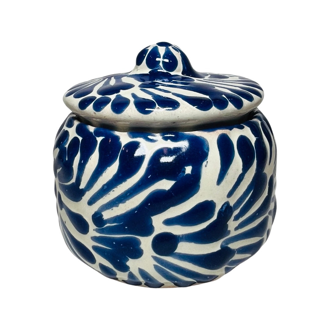 Side view of a ceramic container with a blue and white Puebla design