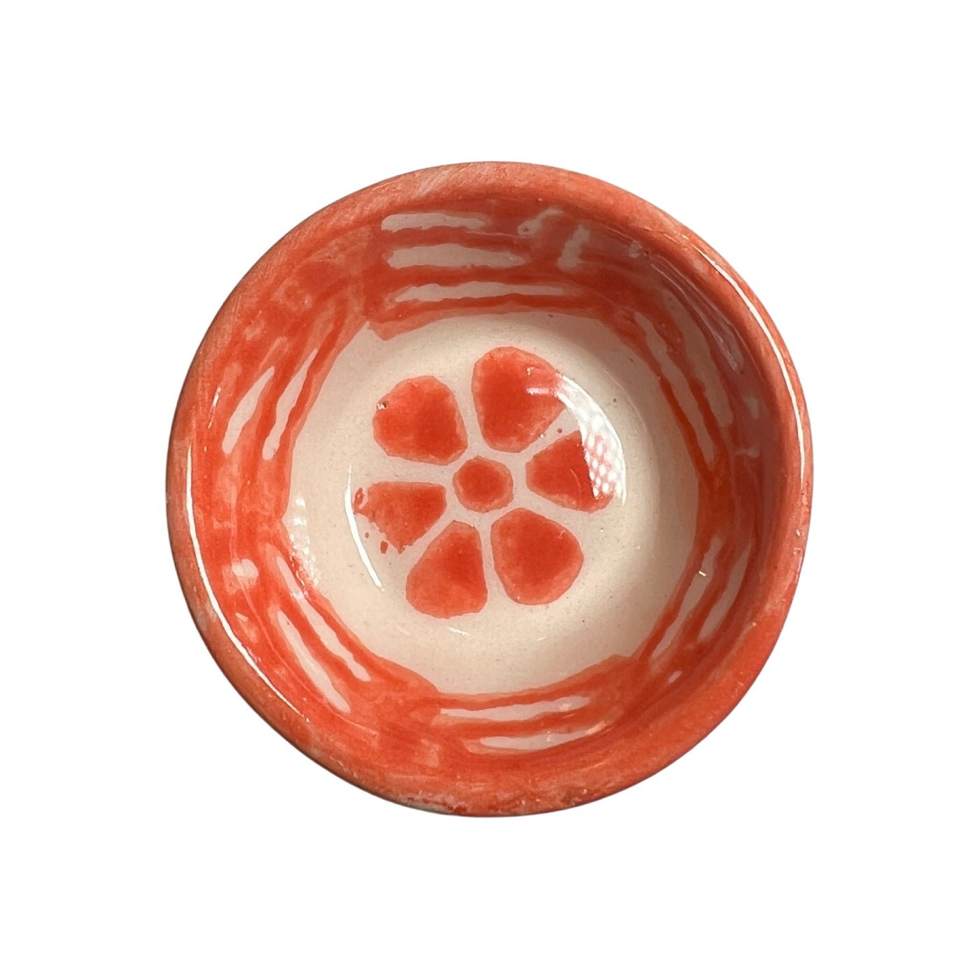 orange ceramic bowl with a flower design