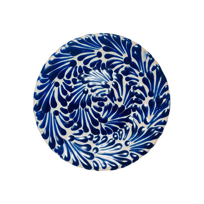 small white plate featuring a blue and white glazed design