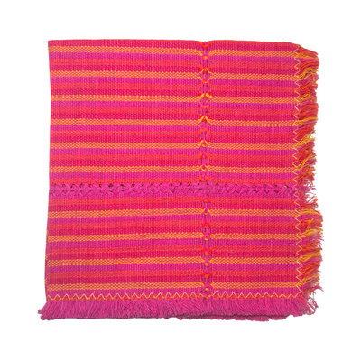 pink and orange striped handwoven napkin folded in quarters