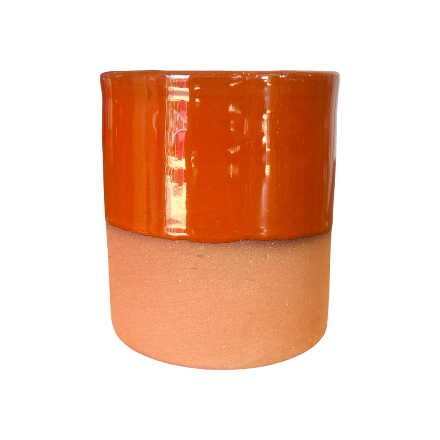 A handcrafted terracotta cup with a rust-colored glazed upper half and an unglazed earthy terracotta base.