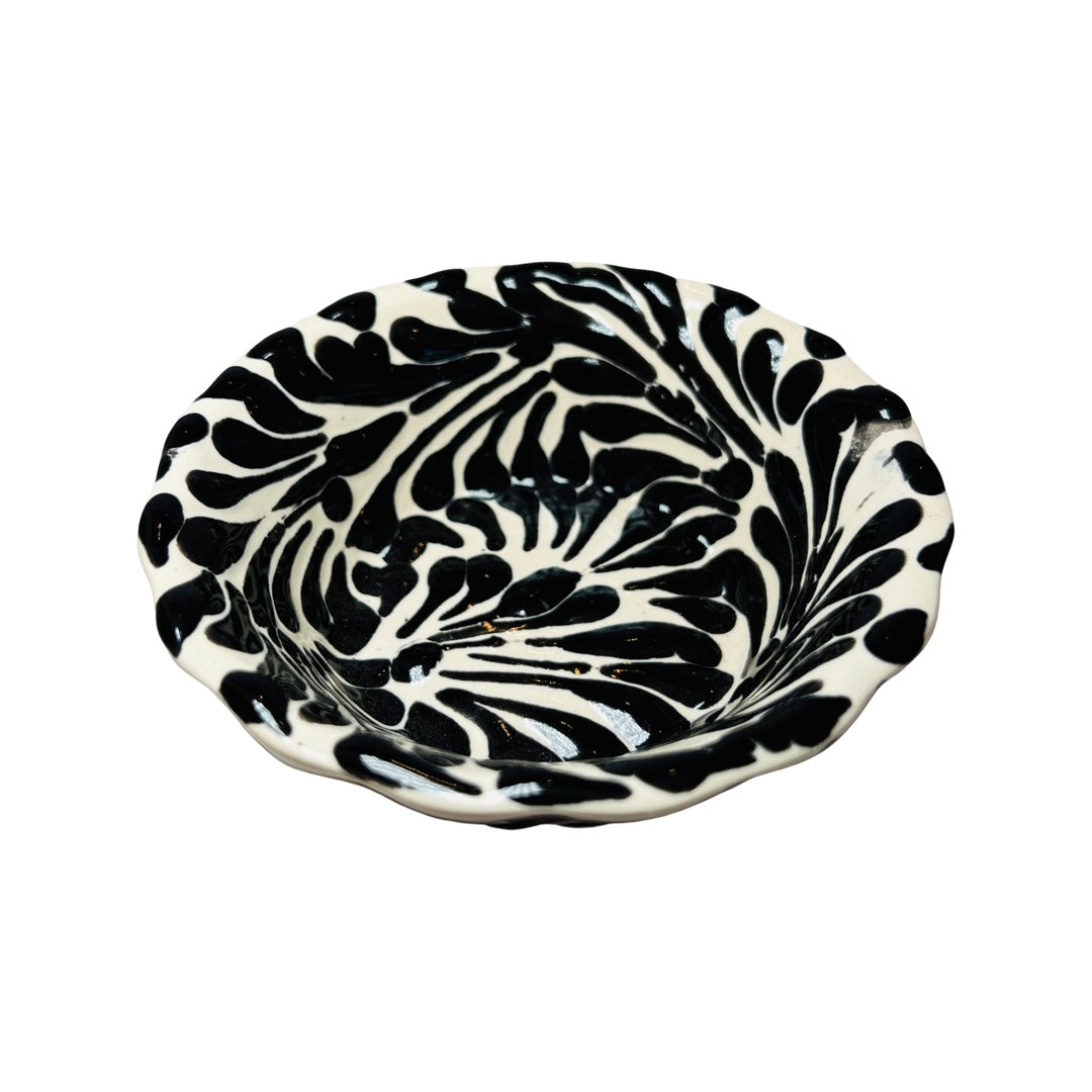 top view of a black and white Puebla design ceramic bowl with a scalloped edge