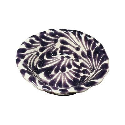 top view of a purple and white Puebla design ceramic bowl with a scalloped edge