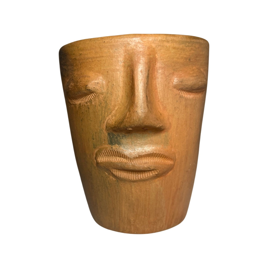 front view photo of clay cup with handsculpted face design