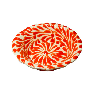 top view of a orange and white Puebla design ceramic bowl with a scalloped edge
