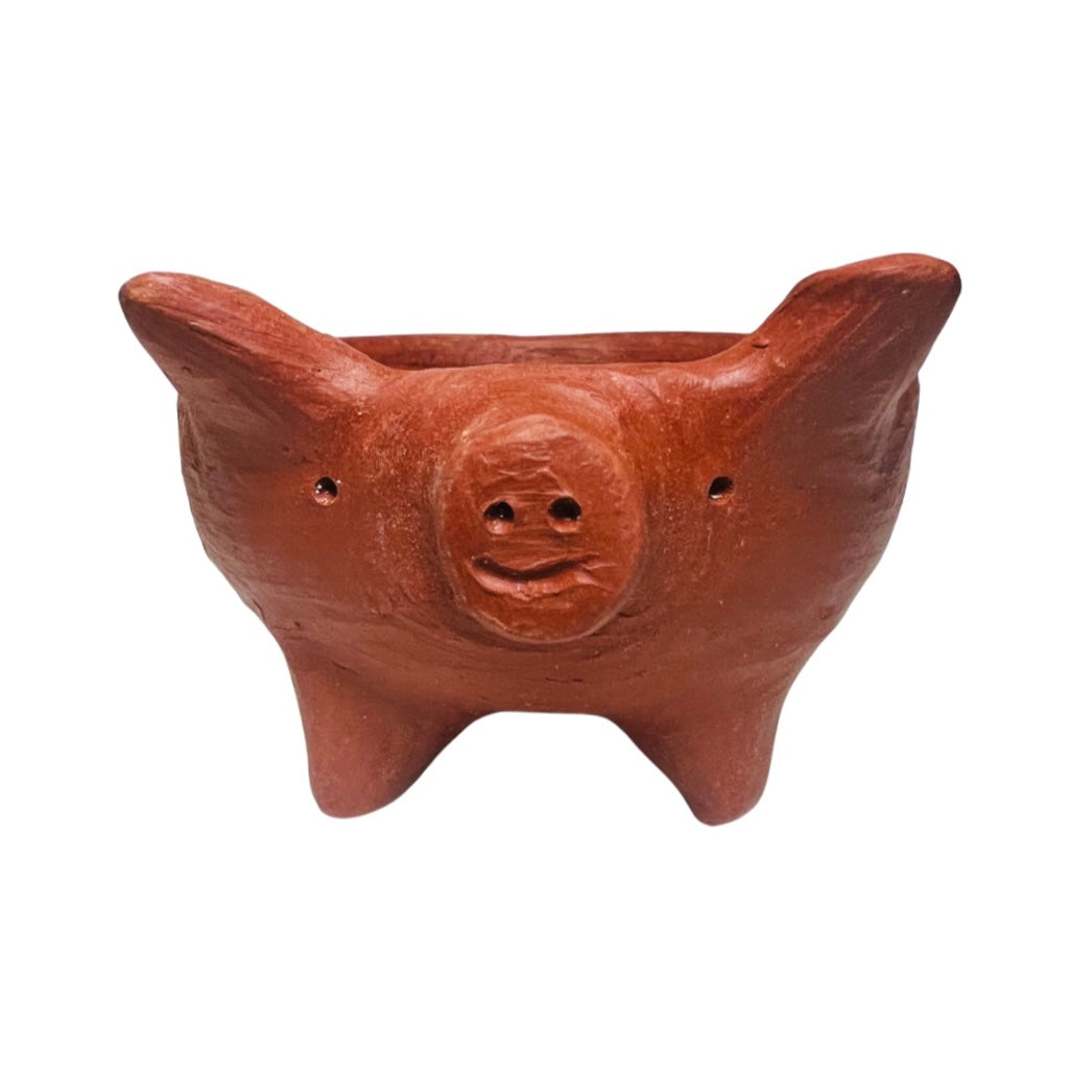 front view of a pig shaped red clay bowl