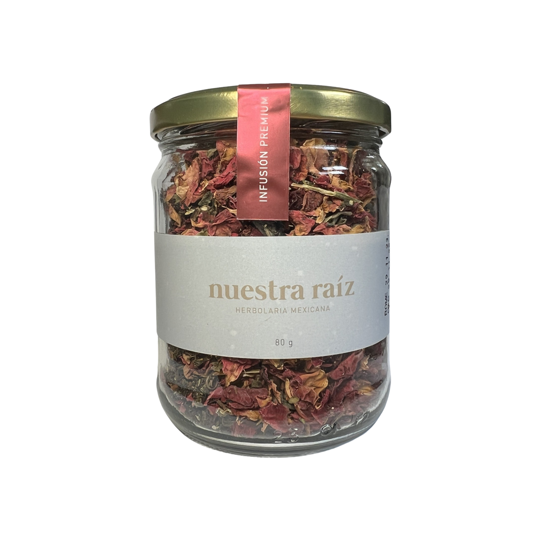 160 gram clear jar of loose leaf tea and dried flowers. Tea leaves and flowers are various shades of reds and pinks.
