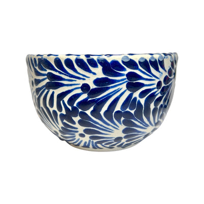 Side view of a ceramic bowl with a blue and white Puebla design