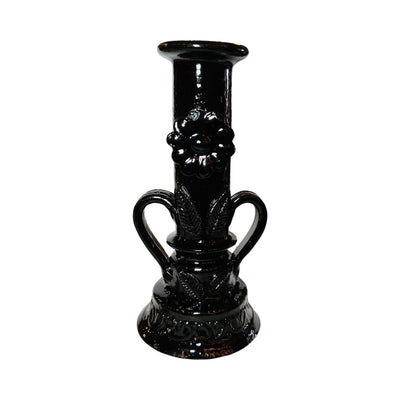 Close up view of the flower detail on black barro candlestick holder