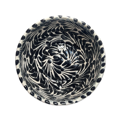 Top view of a ceramic bowl with a white and black Puebla design