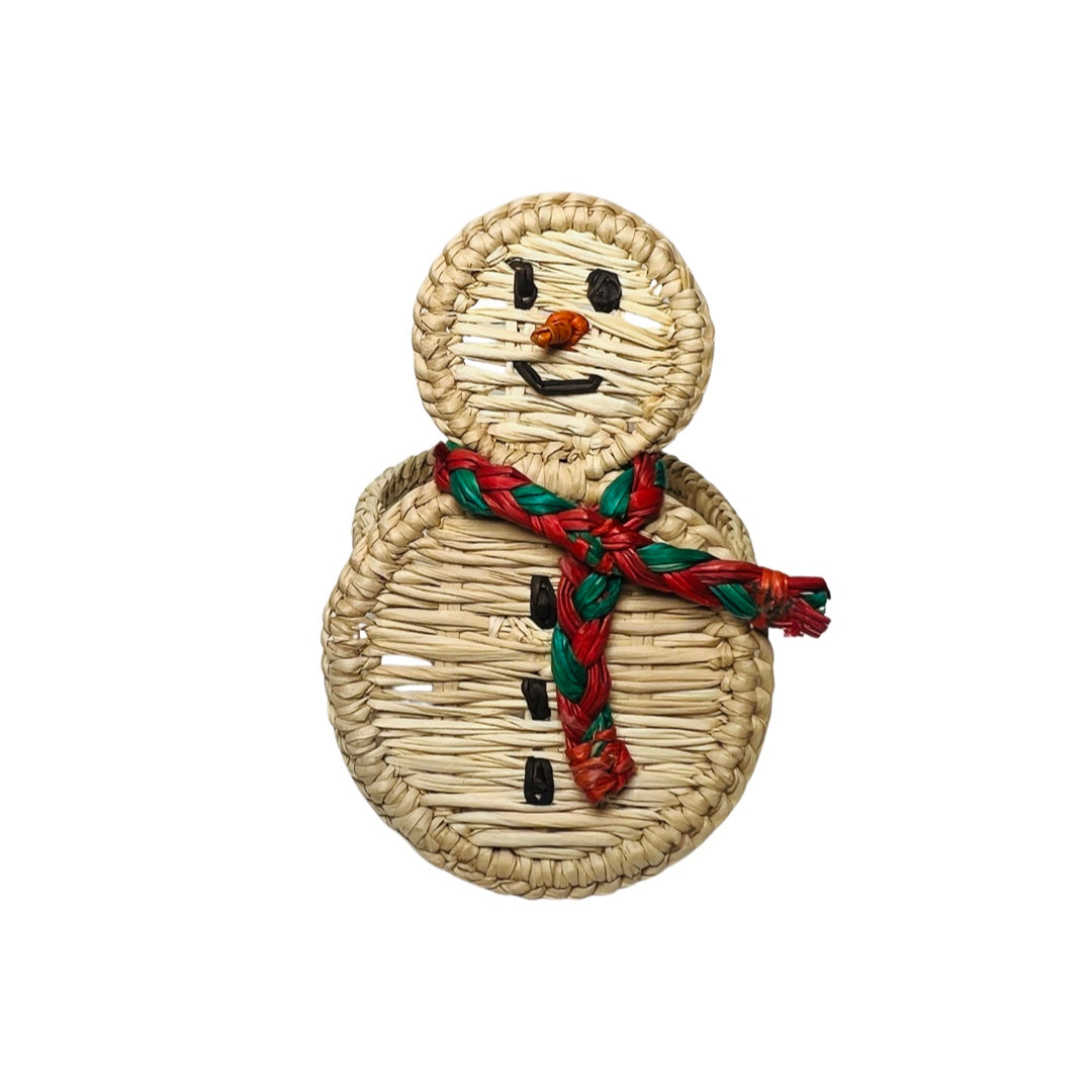 A handcrafted snowman napkin ring made from woven natural fibers, featuring a cheerful face, black button accents, and a braided red and green scarf for a festive touch.