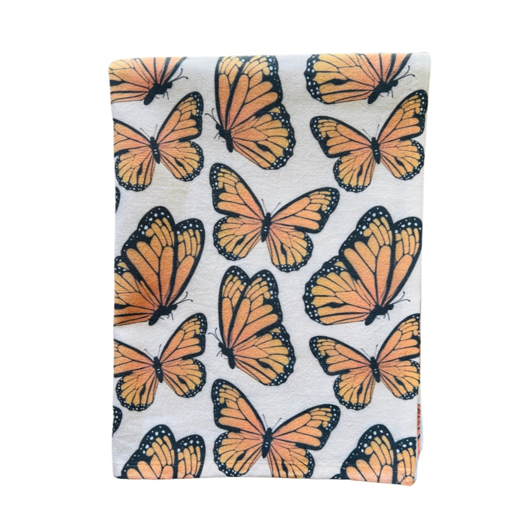 Natural towel with a monarch design folded in quarters