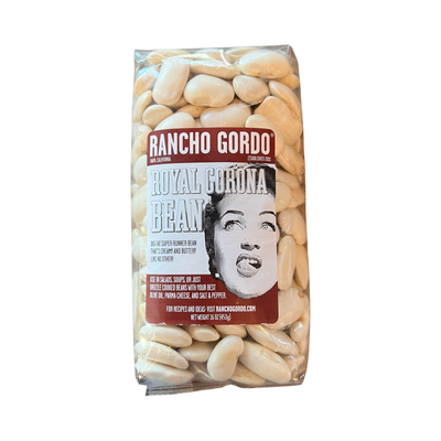 16 oz clear bag of royal corona beans with a white and maroon branded label featuring an image of a woman licking her lips.