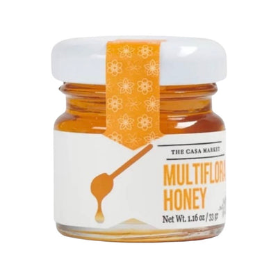 Front view of Multiflora Honey - Mini in clear glass branded jar with white lid