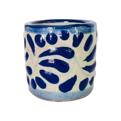 white shot glass with handpainted blue talavera style pattern an blue rim