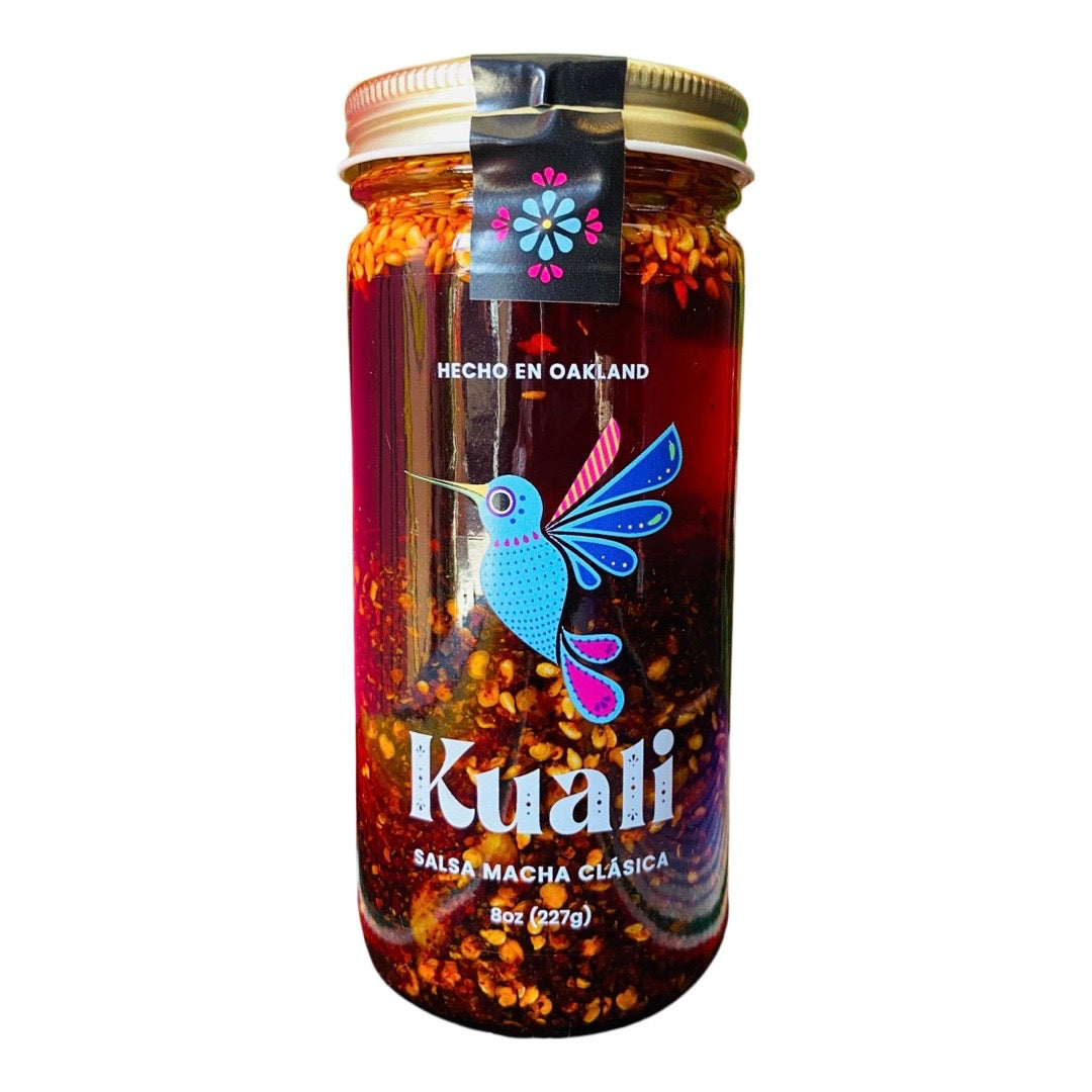 Front view of Kuali Salsa Macha Clasica in clear glass branded jar with gold lid