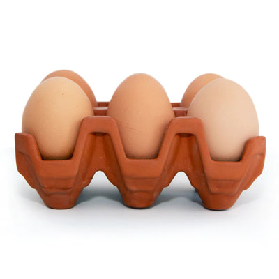 front view of terracotta 6 egg holder with brown eggs in holder.