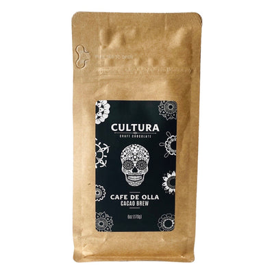 Single 6 ounce craft bag of cafe de olla (coffee from a pot) cacao brew. Label is black and white with a sugar skull in the center and various flowers designs around the border.
