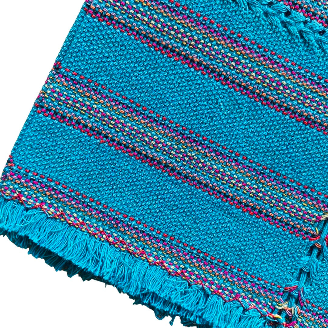 Quarter folded teal cotton napkin with colorful stripes