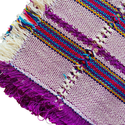 quarter folded purple napkin with colorful horizontal stripes