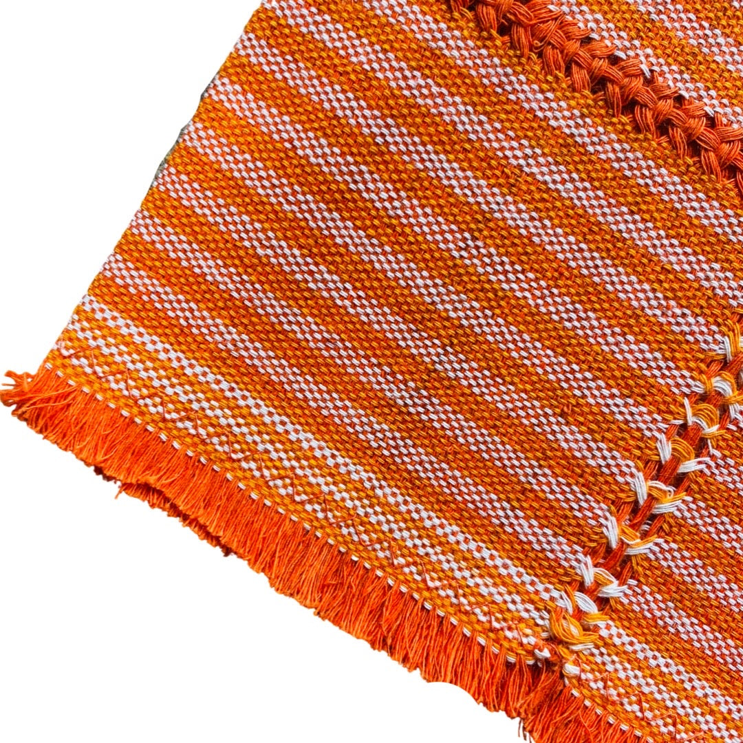 quarter folded orange napkin with white stripes