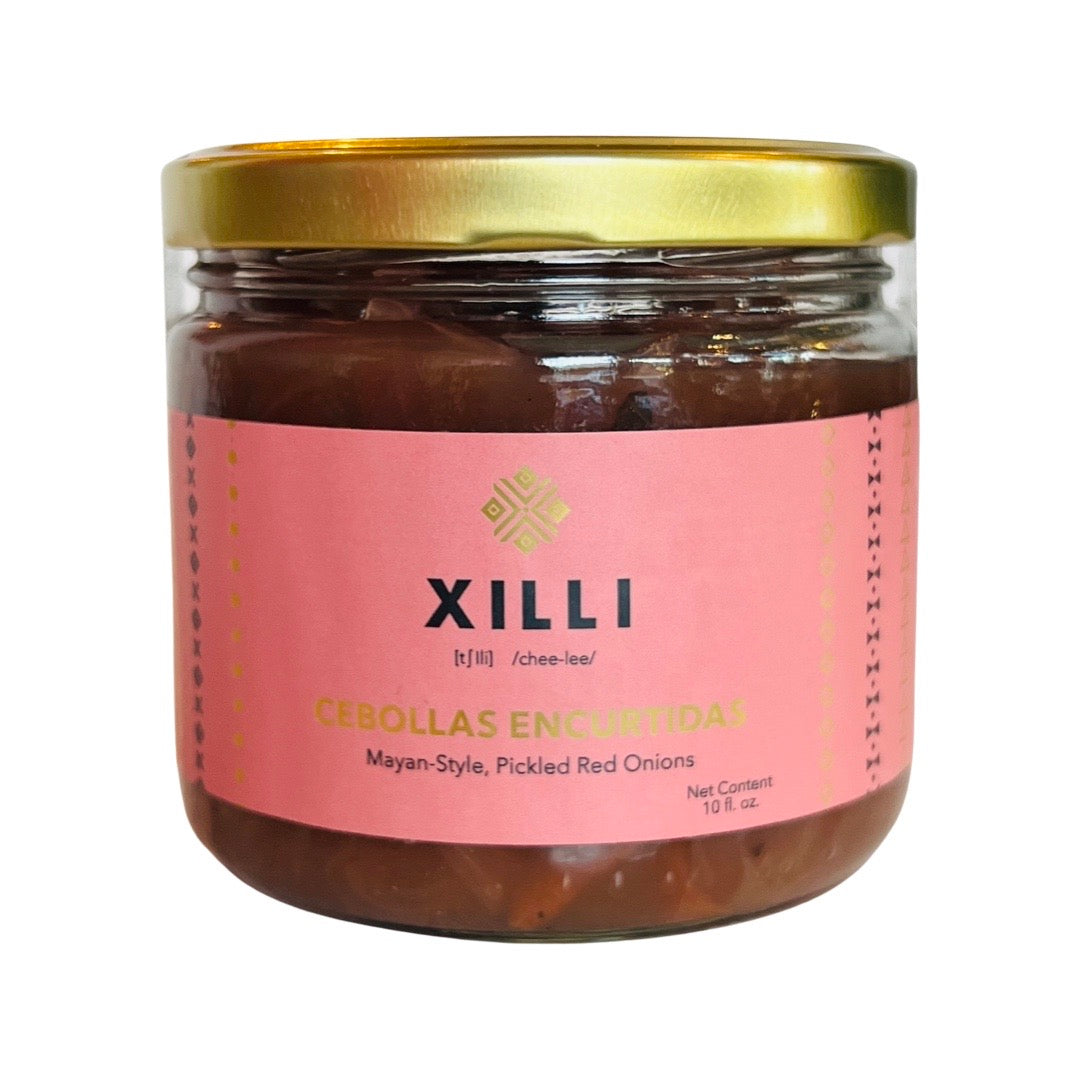10oz clear jar of Cebollas Encurtidas (Pickled Red Onions) with a pink and gold branded label and gold lid