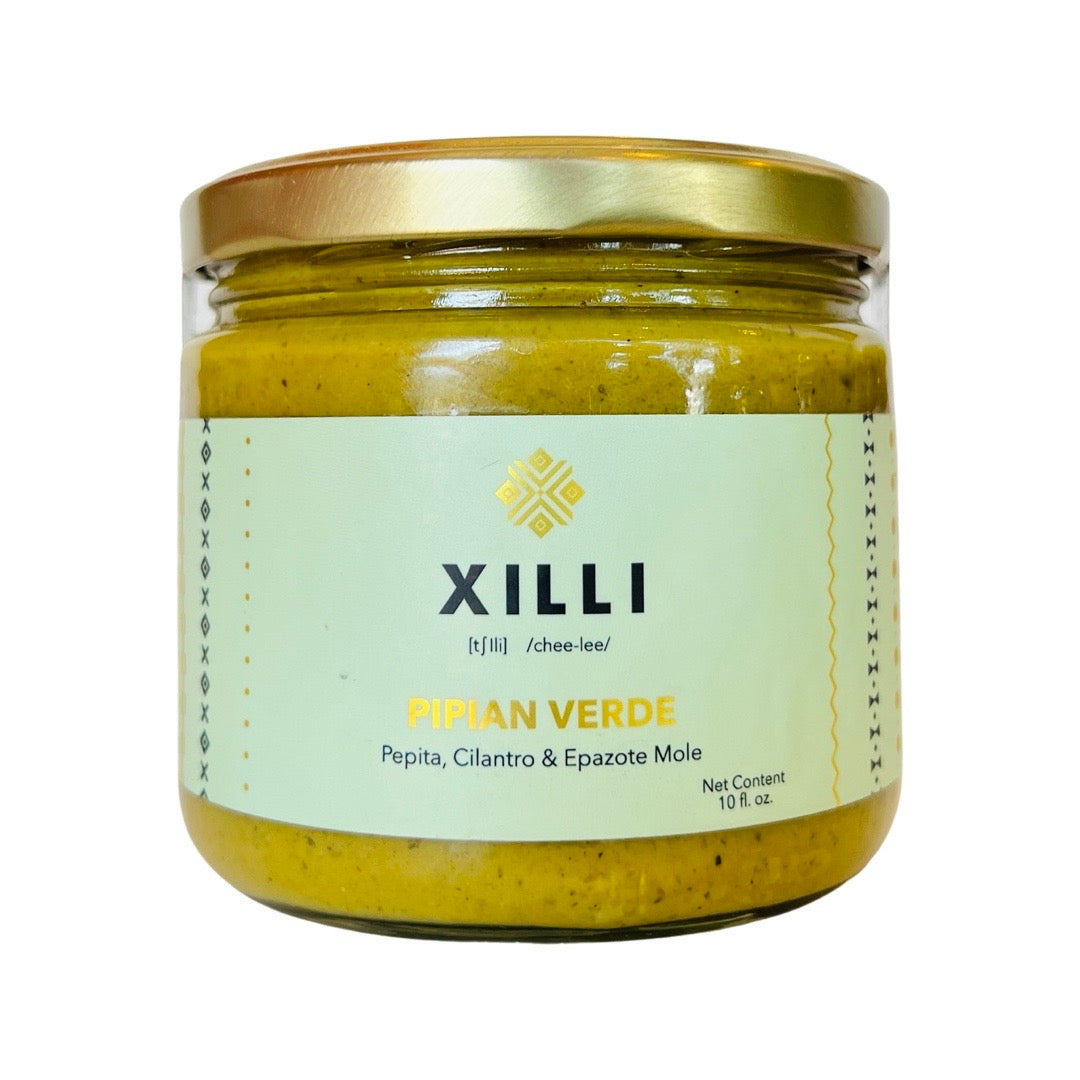 Front view of Pipian Verde in clear glass branded jar with gold colored lid