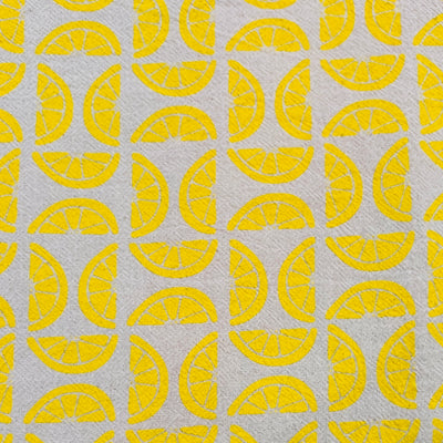 Close-up of a tea towel featuring graphic of sliced lemons.