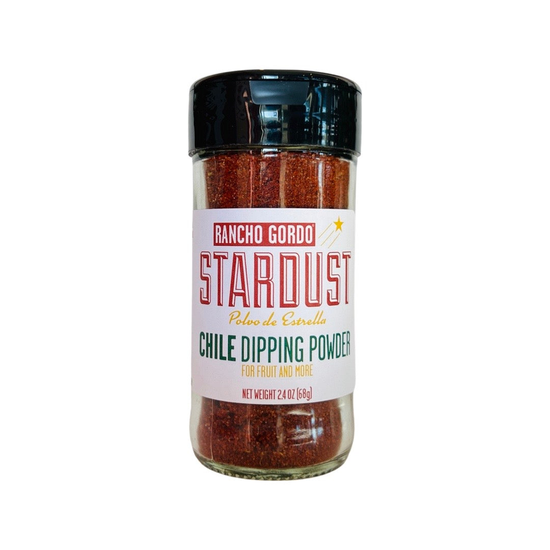 front view of Stardust Chile Dipping Powder in clear glass branded bottle with black lid