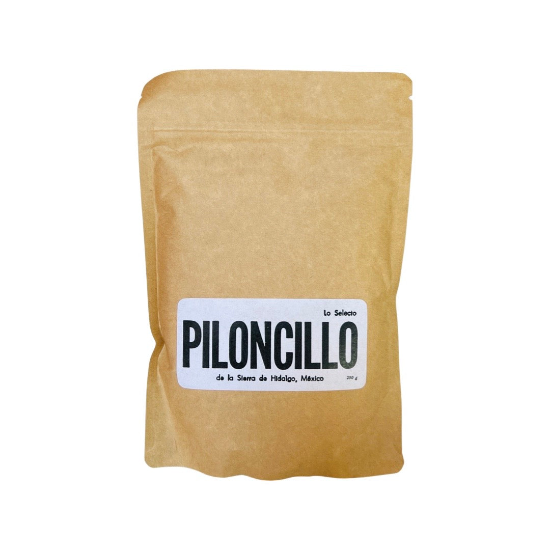 Front view of Piloncillo in brown branded paper packaging