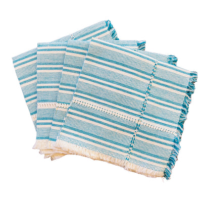 set of four handwoven teal and natural striped napkins folded in quarter.