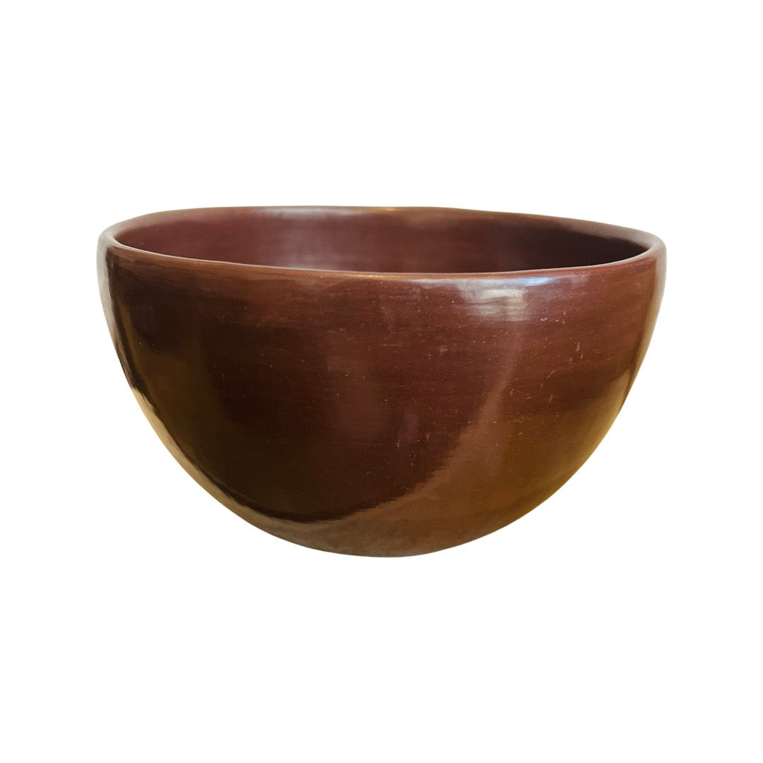 Side view of burnished red clay mini bowl.