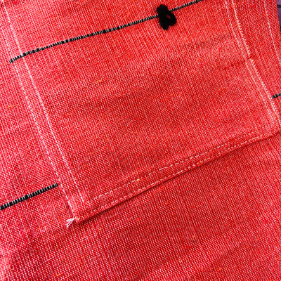 Close up of a Sienna cotton woven apron with two front pockets